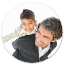 Mature man piggybacking his excited son over white background with copyspace